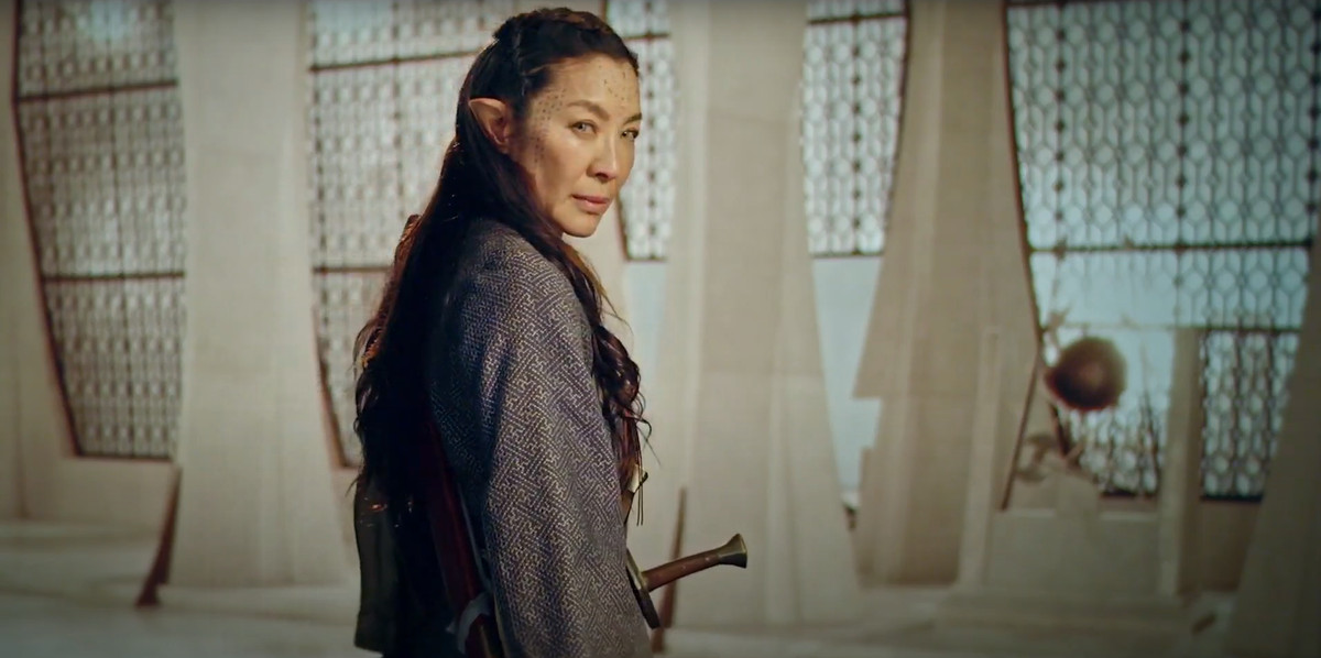 MIchelle Yeoh in the Witcher: Blood Origin standing with a sword in a white room