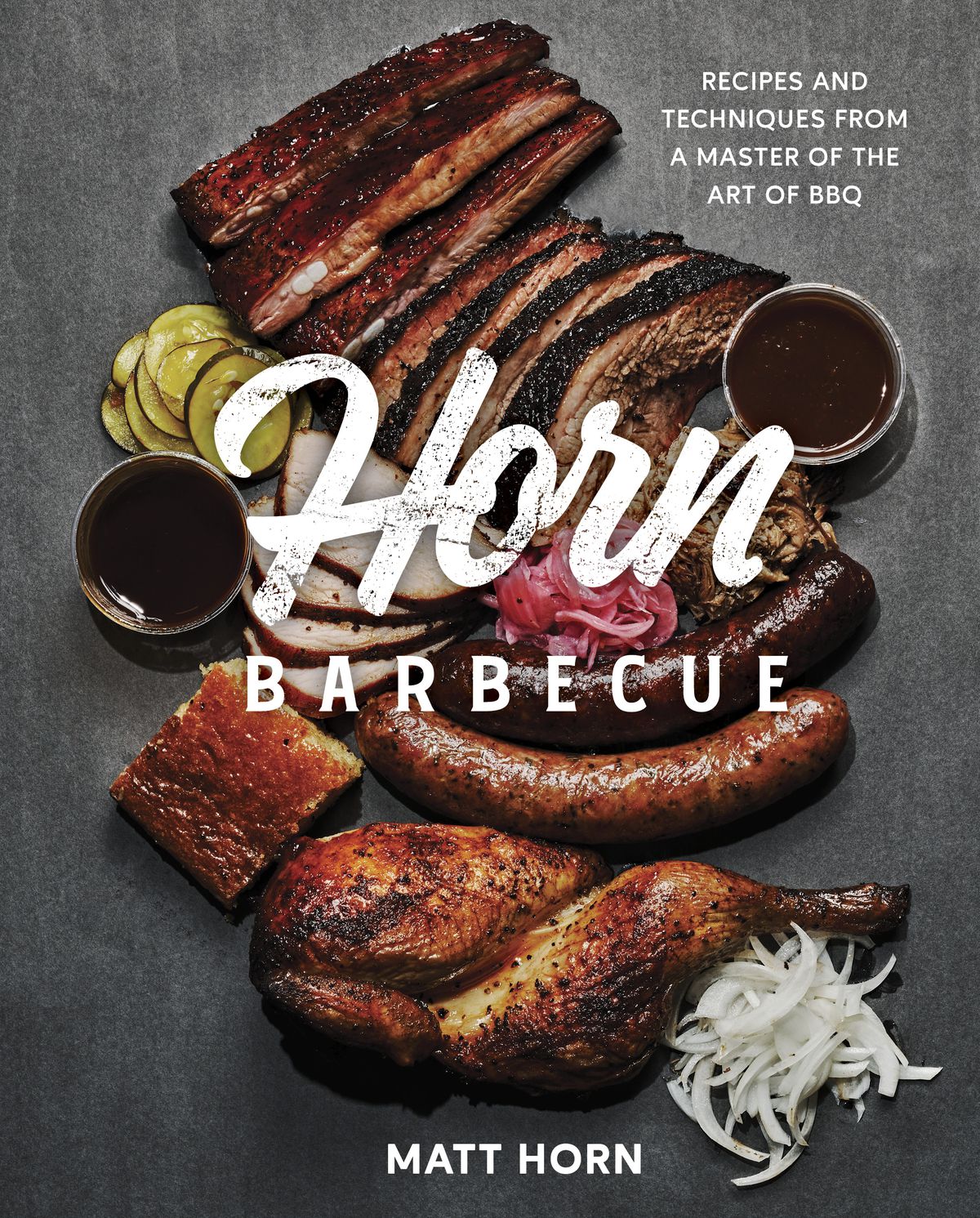 The cover image of the Horn Barbecue cookbook: smoked meats sit on a slate surface.