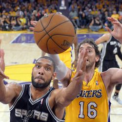 San Antonio Spurs forward Tim Duncan, left, battles for a rebound with Los Angeles Lakers forward Pau Gasol, of Spain, during the first half in Game 3 of a first-round NBA basketball playoff series, Friday, April 26, 2013, in Los Angeles. 