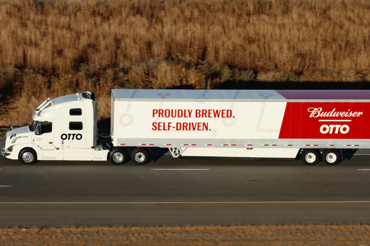 An 18-wheel truck driving down a highway reads, “Otto” and “Proudly brewed. Proudly self-driven.”