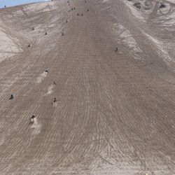 Riders line up to challenge the 700-foot-high Sand Mountain at Little Sahara recreation area.