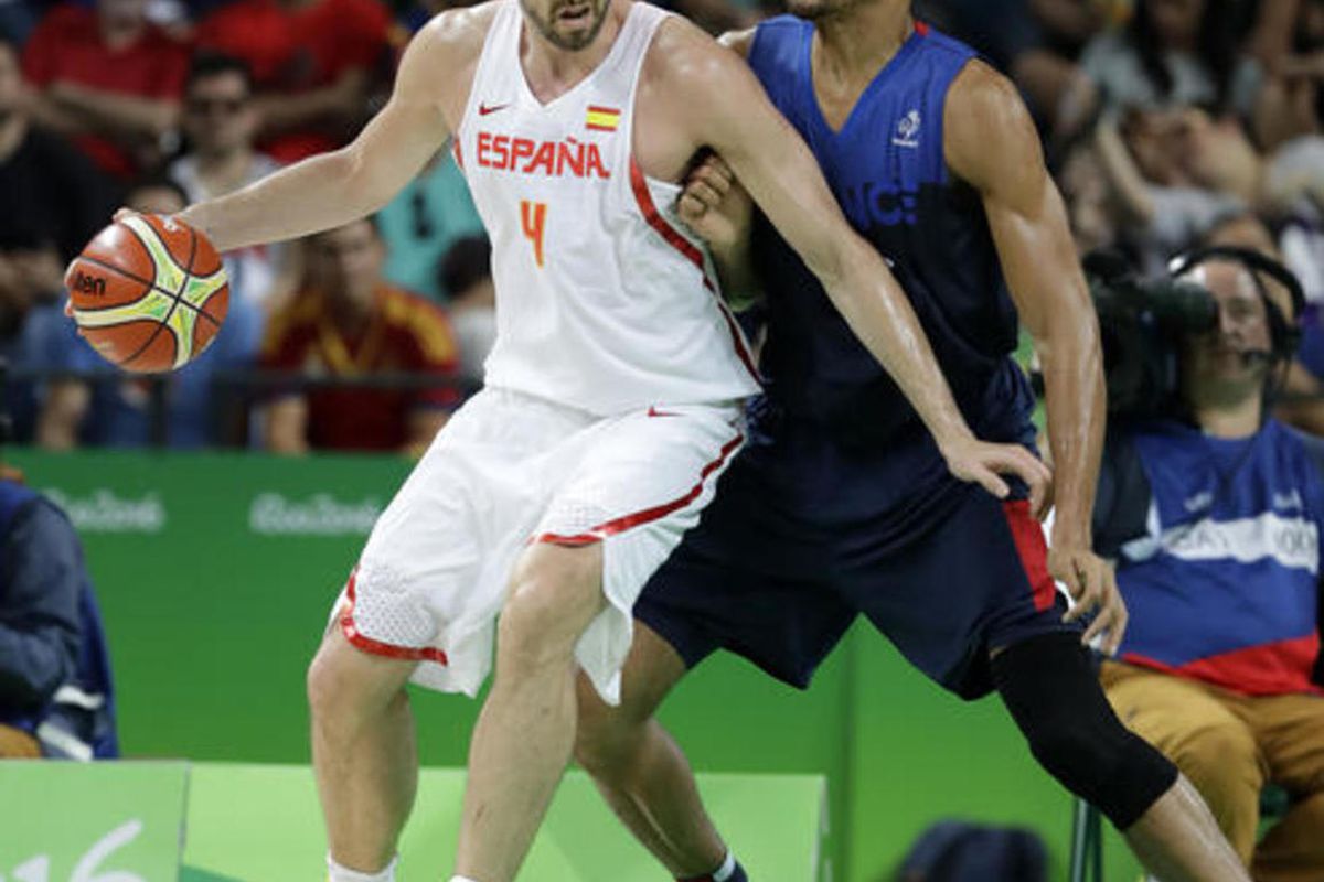 Spain's Pau Gasol (4) drives around France's Rudy Gobert, right, during a quarterfinal round basketball game at the 2016 Summer Olympics in Rio de Janeiro, Brazil, Wednesday, Aug. 17, 2016. 