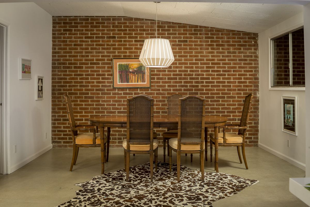 Dining room with brick wall