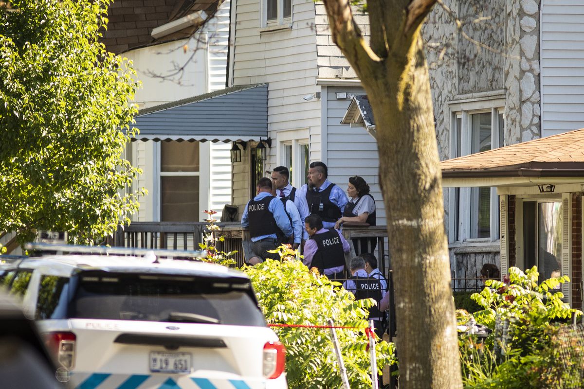 Chicago police officials investigate inside a house in the 6200 block of South Morgan, where eight people were shot, four fatally, during an argument inside the Englewood building, Tuesday afternoon, June 15, 2021.
