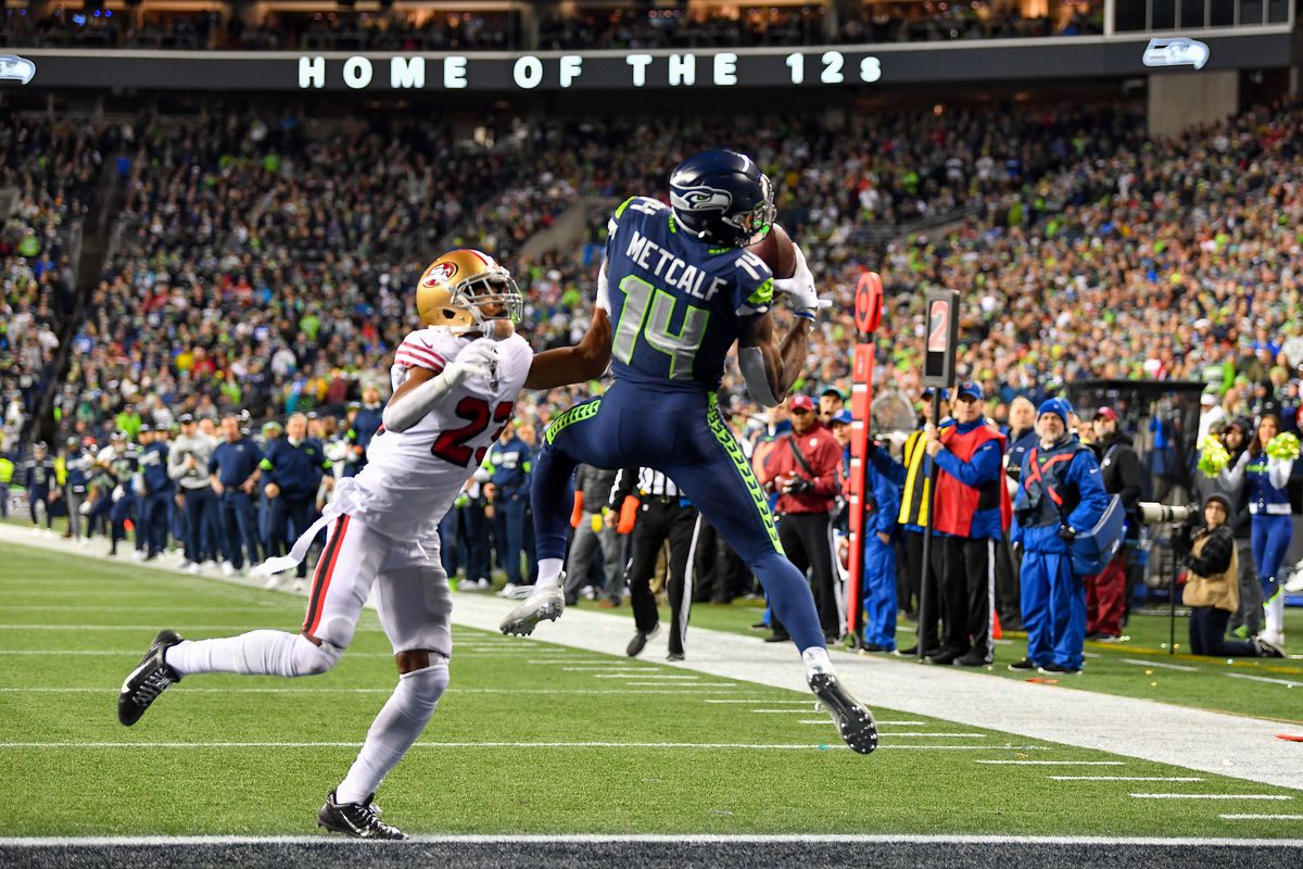 D.K. Metcalf of the Seattle Seahawks scores on a 14 yard touchdown pass from Russell Wilson during the fourth quarter of the game against the San Francisco 49ers at CenturyLink Field on December 29, 2019 in Seattle, Washington.