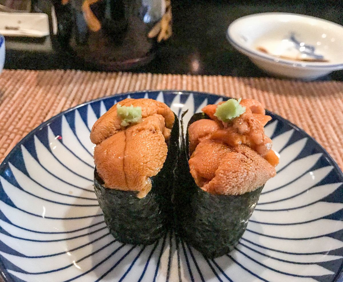 Two kinds of uni at Kura Sushi, West Hollywood on a blue and white plate at the counter.
