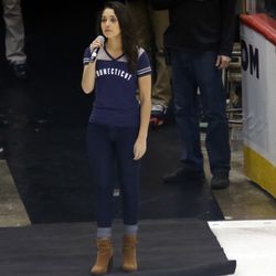Gina Salvatore sings the national anthem before the Northeastern Huskies vs UConn Huskies men's college ice hockey game game at the XL Center in Hartford, CT  on November 28, 2017.