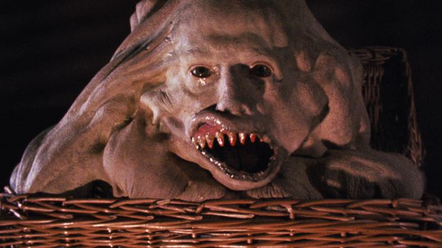 A mutant child sits in a basket with its mouth agape in Basket Case.