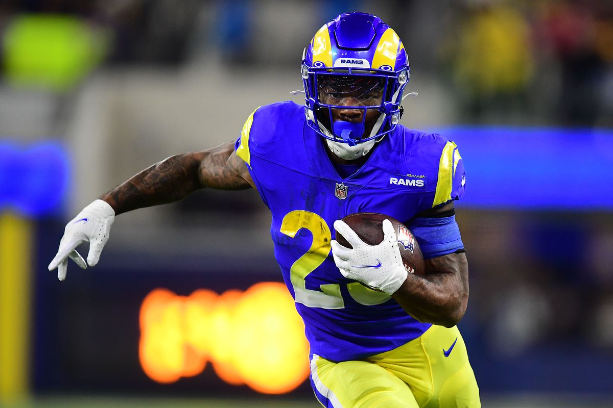 Los Angeles Rams running back Cam Akers (23) runs the ball against the Arizona Cardinals during the second half in the NFC Wild Card playoff football game at SoFi Stadium.