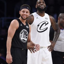 Team Stephen's Stephen Curry, left, of the Golden State Warriors, and Team LeBron's LeBron James, of the Cleveland Cavaliers, stand together during the first half of an NBA All-Star basketball game, Sunday, Feb. 18, 2018, in Los Angeles. (AP Photo/Chris Pizzello)