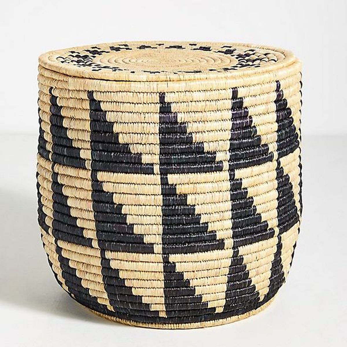 Woven basket table with black pattern. 