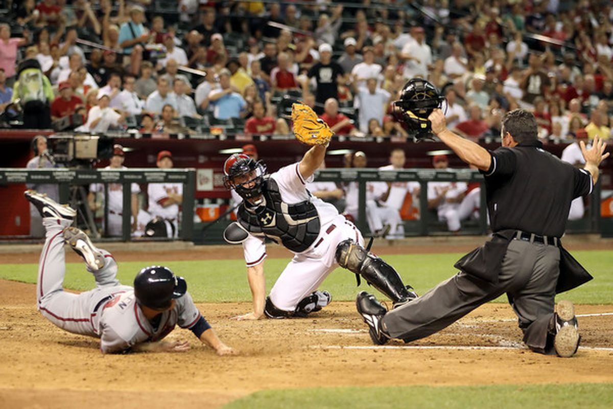 Kris Medlen slides in safe at home for what was then the tying run. 