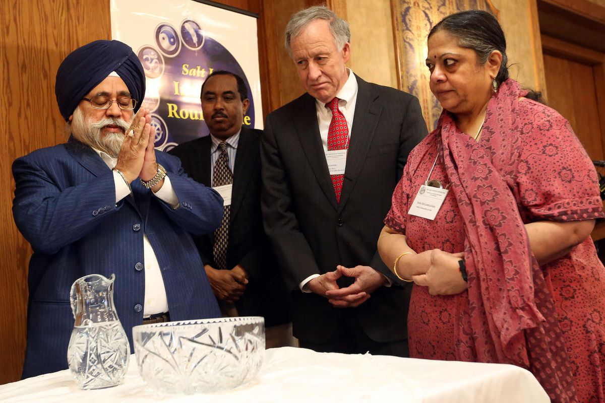 FILE - From left, J.B. Singh, Osman Ahmed, Jim Jardine and Indra Neelameggham participate in a water ceremony, each pouring water into a common bowl to symbolize different faiths coming together in harmony, during the Interfaith Roundtable"™s annual Inter