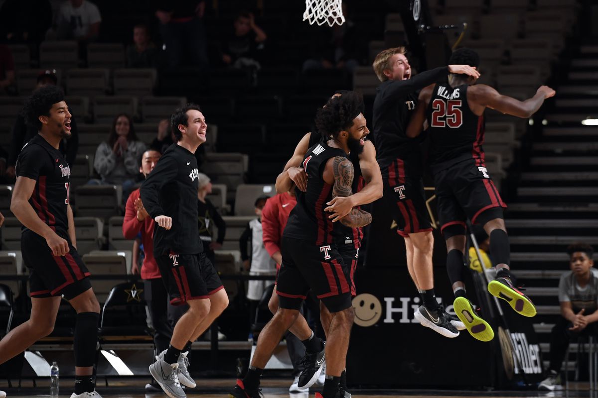 Temple Owls players celebrate after an overtime win against the Vanderbilt Commodores at Memorial Gymnasium.