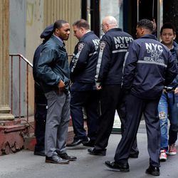New York City Police and members of the Office of the Chief Medical Examiner enter a building in Lower Manhattan Monday, April 29, 2013, near the place where a rusted metal part from the wing of a Boeing 767 was found wedged between a mosque and an apartment building on Friday, April 26. Investigators initially thought it was part of the landing gear, because both pieces have similar hydraulics. Authorities believe the aircraft part is from one of the two hijacked planes used in the Sept. 11 attacks on the nearby World Trade Center. The medical examiner's office said Monday it is preparing the site and plans to begin sifting for human remains in the area on Tuesday, April 30. 
