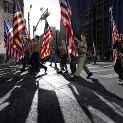 Boy Scouts carry U.S. flags up Congress Avenue towards the Texas Capitol during the annual Boy Scouts Parade and Report to State, Saturday, Feb. 2, 2013, in Austin, Texas.