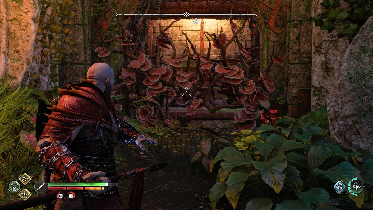 Kratos stares at some flammable vines in God of War Ragnarok’s Vanaheim region.
