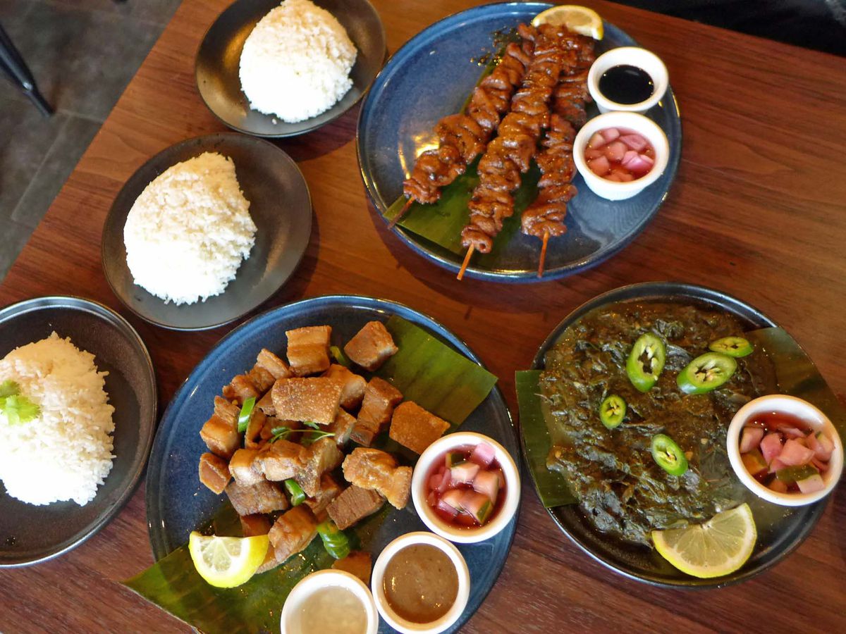 Three dishes accompanied by bowls of white rice.
