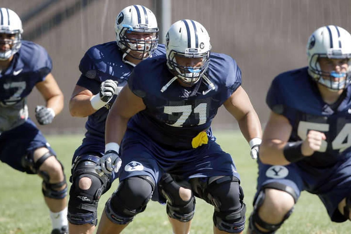 Members of the offensive line work out during BYU football practice Tuesday, Aug. 16, 2011.