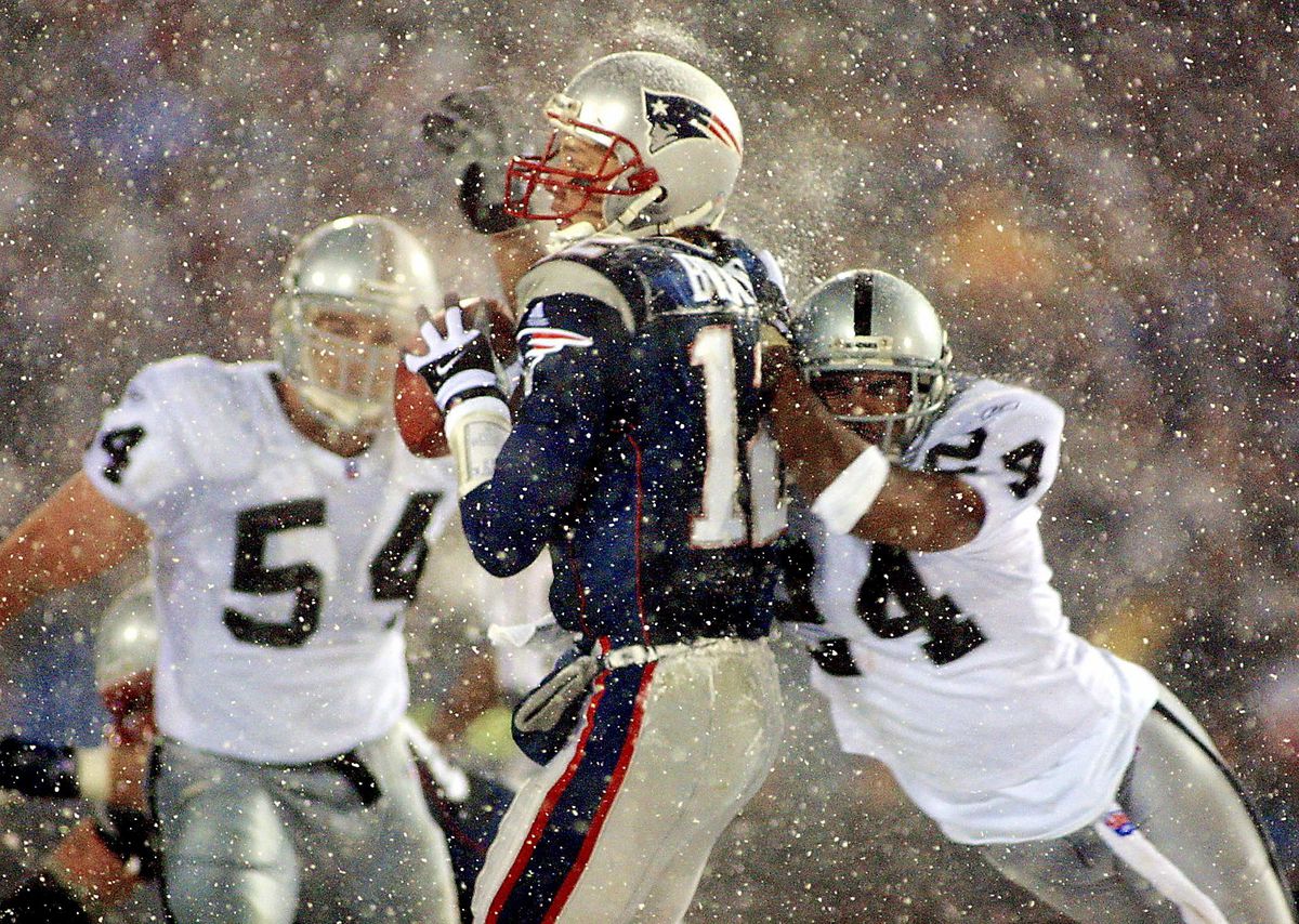 New England Patriots quarterback Tom Brady (C) ta