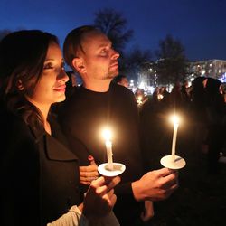 Spencer and Bahar Ferguson hold candles during a candlelight vigil in Salt Lake City on Thursday, Dec. 20, 2018, at Pioneer Park to remember the 121 homeless men and women who died during the year.