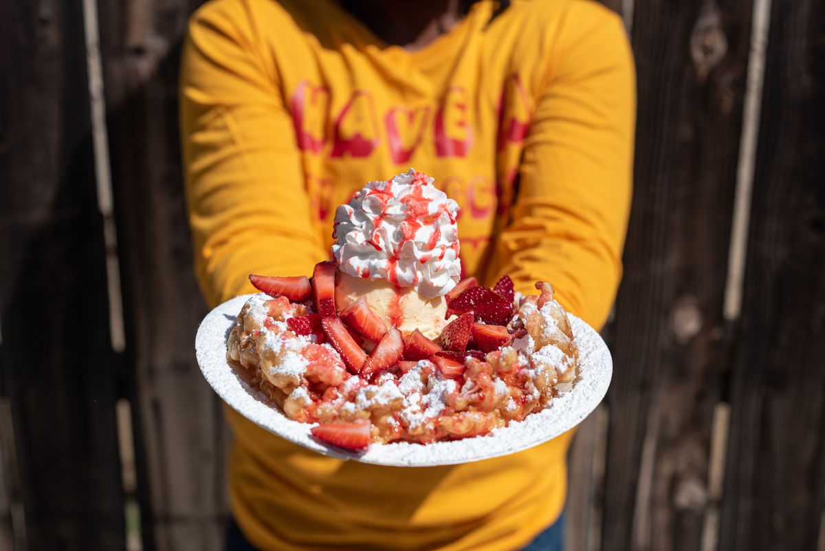 Fun Diggity funnel cakes owner Cheyenne Brown holds a funnel cake in front of her home in Compton, California.