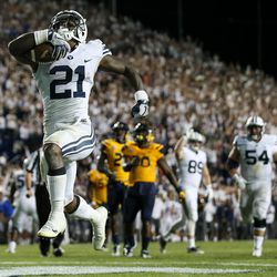 Brigham Young Cougars running back Jamaal Williams (21) runs the ball for a touchdown, his fifth of the game, making the score 52-45 after the PAT, during a game against the Toledo Rockets at LaVell Edwards Stadium in Provo on Friday, Sept. 30, 2016.