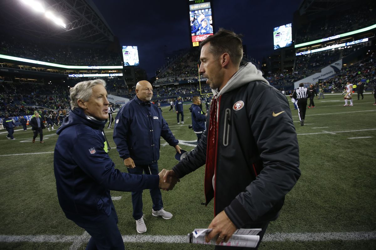 Head Coach Pete Carroll of the Seattle Seahawks and Head Coach Kyle Shanahan of the San Francisco 49ers shake hands on the field following the game at CenturyLink Field on December 2, 2018 in Seattle, Washington.
