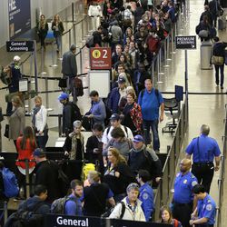 In this March 17, 2016, photo, travelers wait in line for security screening at Seattle-Tacoma International Airport in Seattle. Fliers will likely face massive security lines at airports across the country this summer, with airlines already warning passengers to arrive at least two hours early or risk missing their flight. 