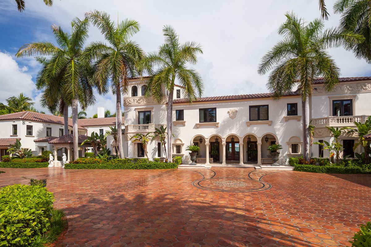 View of a gorgeous goliath mediterannean mansion on miami beach with orange tile.