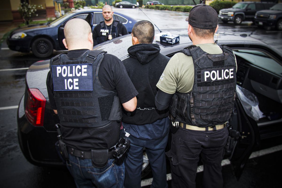 ICE agents conduct an arrest.