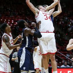 Utah Utes forward Jayce Johnson (34) and Concordia’s Drew Martin compete for a rebound during a game at the Hunstman Center in Salt Lake City on Tuesday, Nov. 15, 2016.