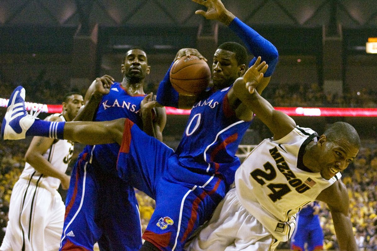 COLUMBIA, MO - FEBRUARY 04:    Thomas Robinson #0 of the Kansas Jayhawks grabs a rebound from Kim English #24 of the Missouri Tigers during the first half at Mizzou Arena on February 4, 2012 in Columbia, Missouri. (Photo by Ed Zurga/Getty Images)