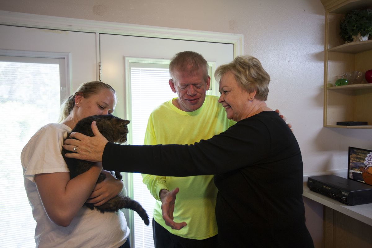 Celestia Cragun and her granddaughter Caitlin Shrive try to get her son Robbie, 40, to pet her husband's cat at their home in Cottonwood Heights, Utah, on Saturday, June 8, 2019. Cragun's husband passed away in February of this year and she has been takin