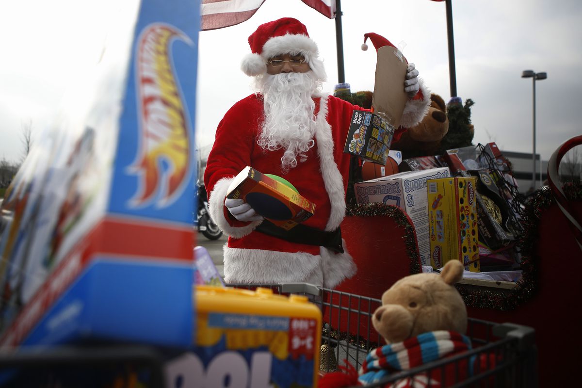 Ruben Rojas, of Burbank, Ill., unloads gifts from his motorcycle trailer at the end of the parade in 2012.