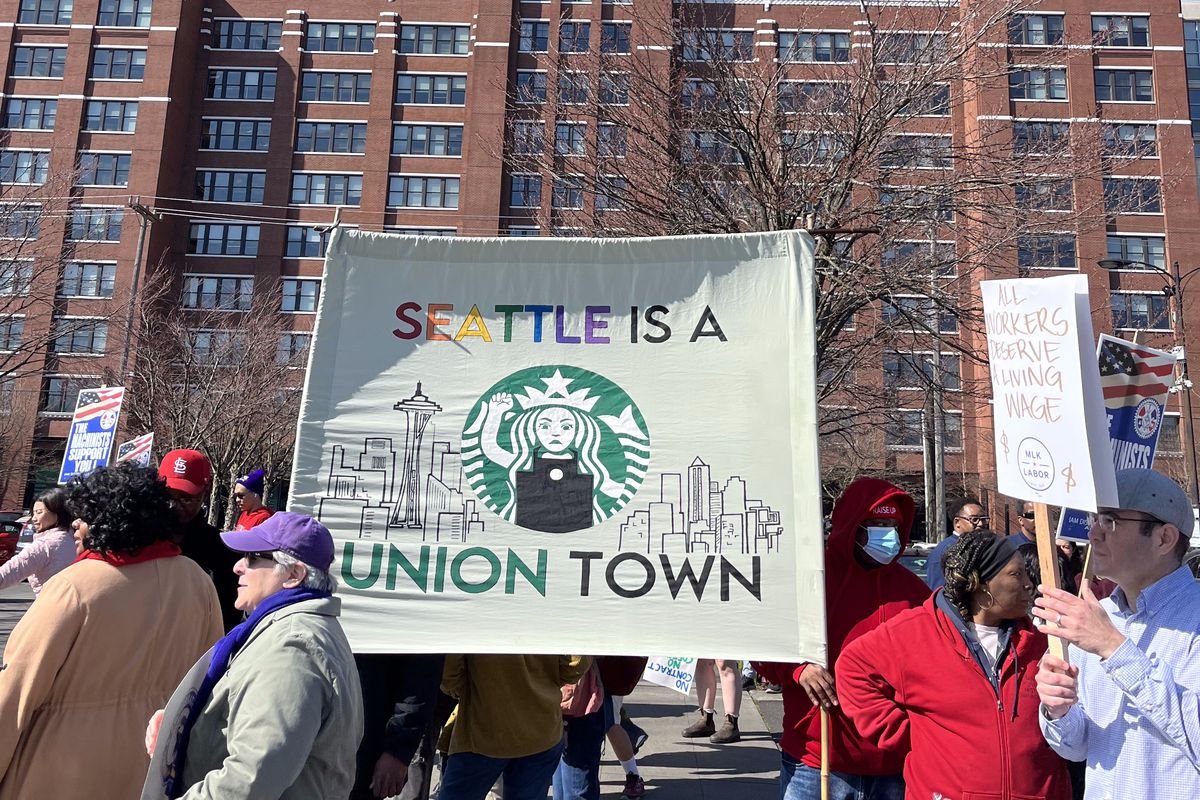 Protesters hold up a sign reading “Seattle is a union town.”