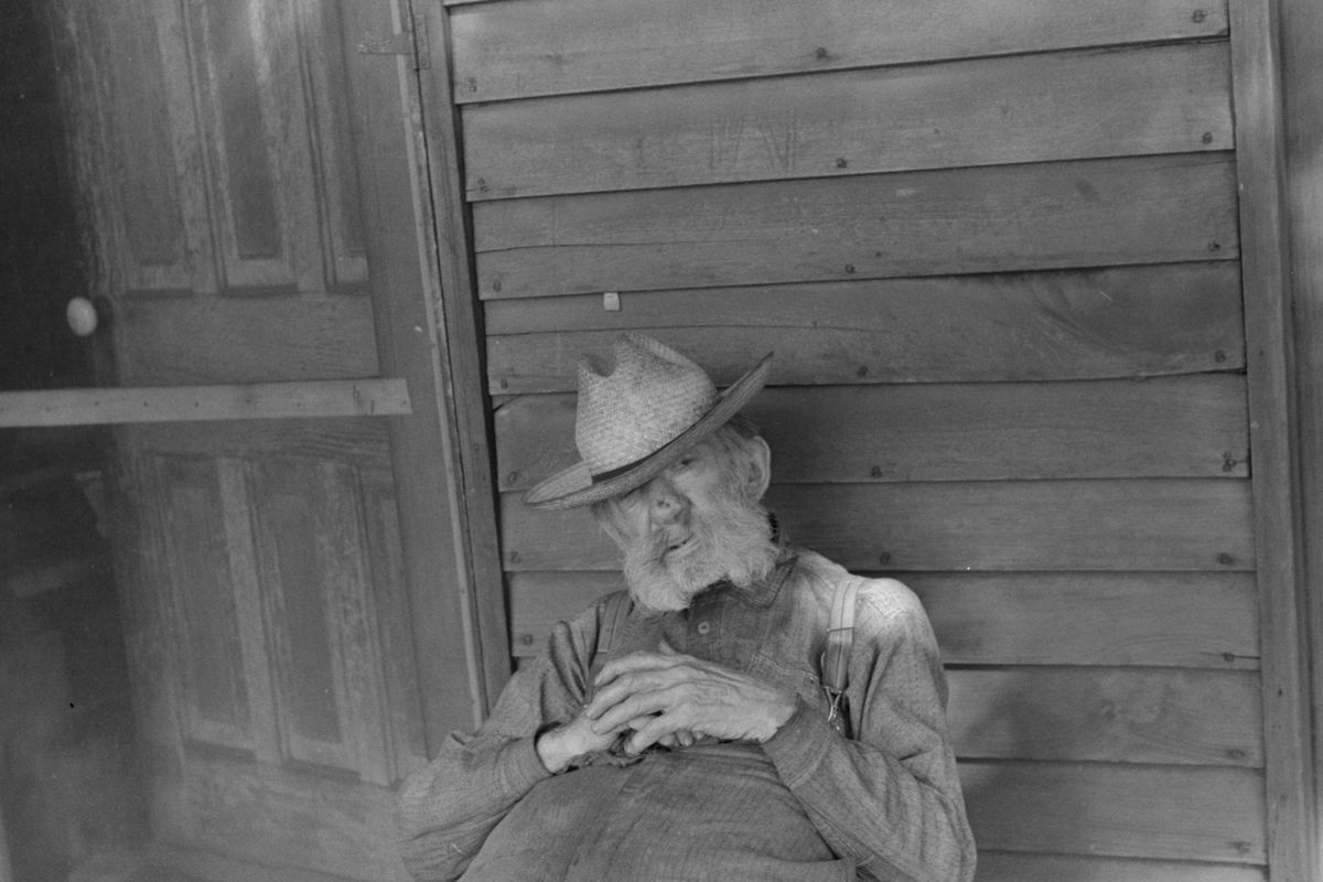 Ex-farmer resting by a house in Circleville,1938