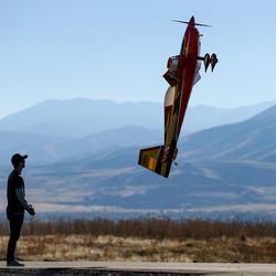 Brandon Reimschiissel flies his remote control Pilot Extra 330 vertical at an opening ceremony for the new SLC Modelport in Salt Lake City on Wednesday, Nov. 2, 2016.
