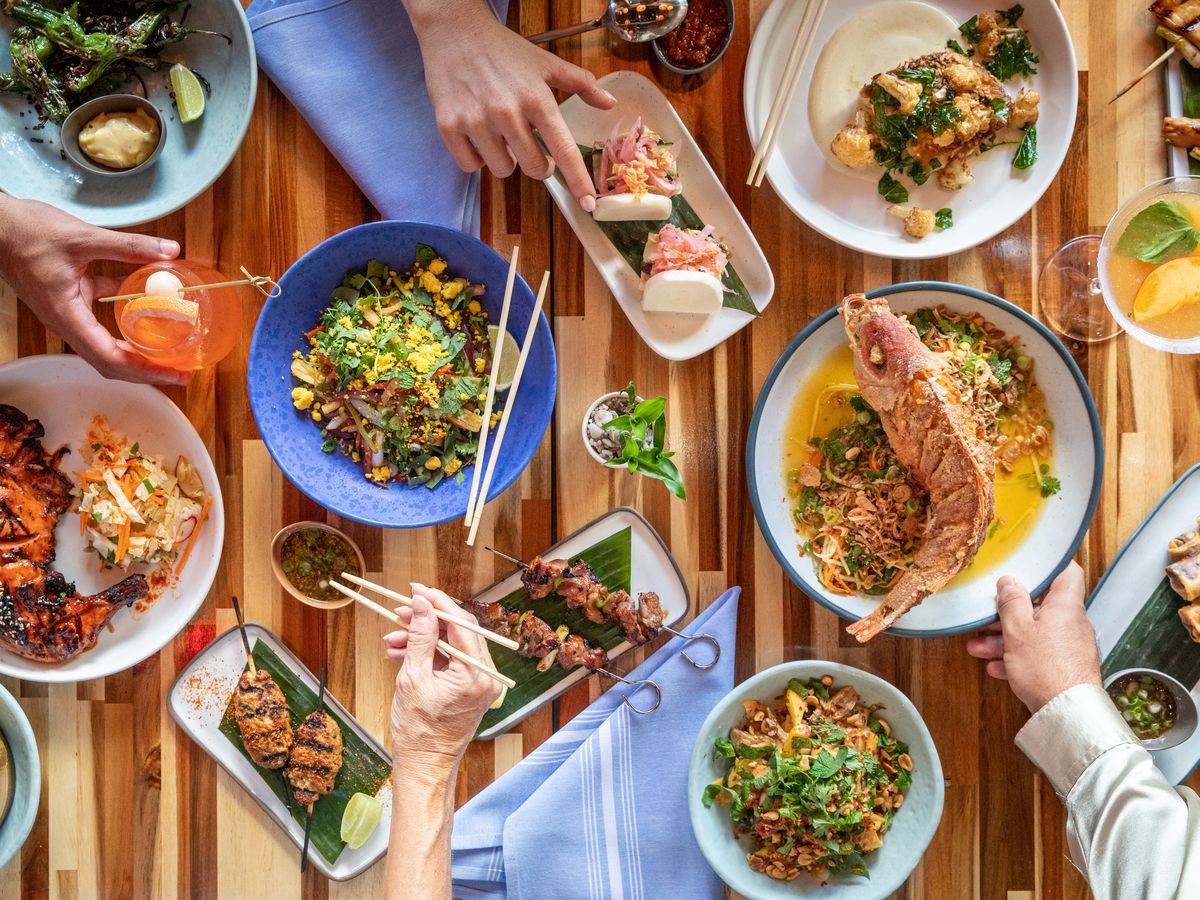 A table full of colorful dishes.