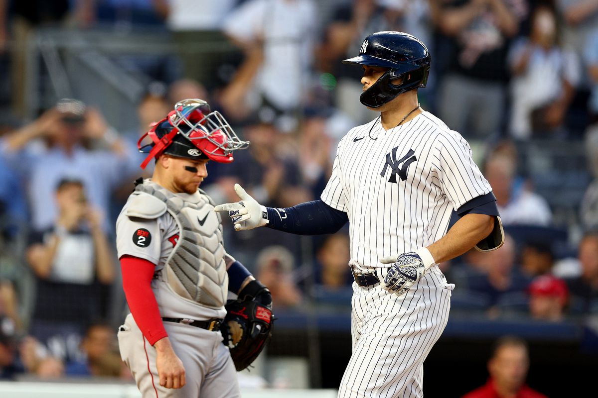 Giancarlo Stanton #27 of the New York Yankees reacts after he hit a three run home run in the third inning as Christian Vazquez #7 of the Boston Red Sox looks on at Yankee Stadium on July 15, 2022 in the Bronx borough of New York City.