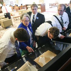 Sister Kathleen Harper, a missionary serving at The Church of Jesus Christ of Latter-day Saints' Church History Library, second from left, talks to follow missionaries — Elders Jacob Wamsley, William Skyler Hall, Dylan Tribe, Nolan McNeely and Jared Moore, left to right — as they view pages from the printer's manuscript of the Book of Mormon at the library in Salt Lake City on Thursday, Sept. 21, 2017.