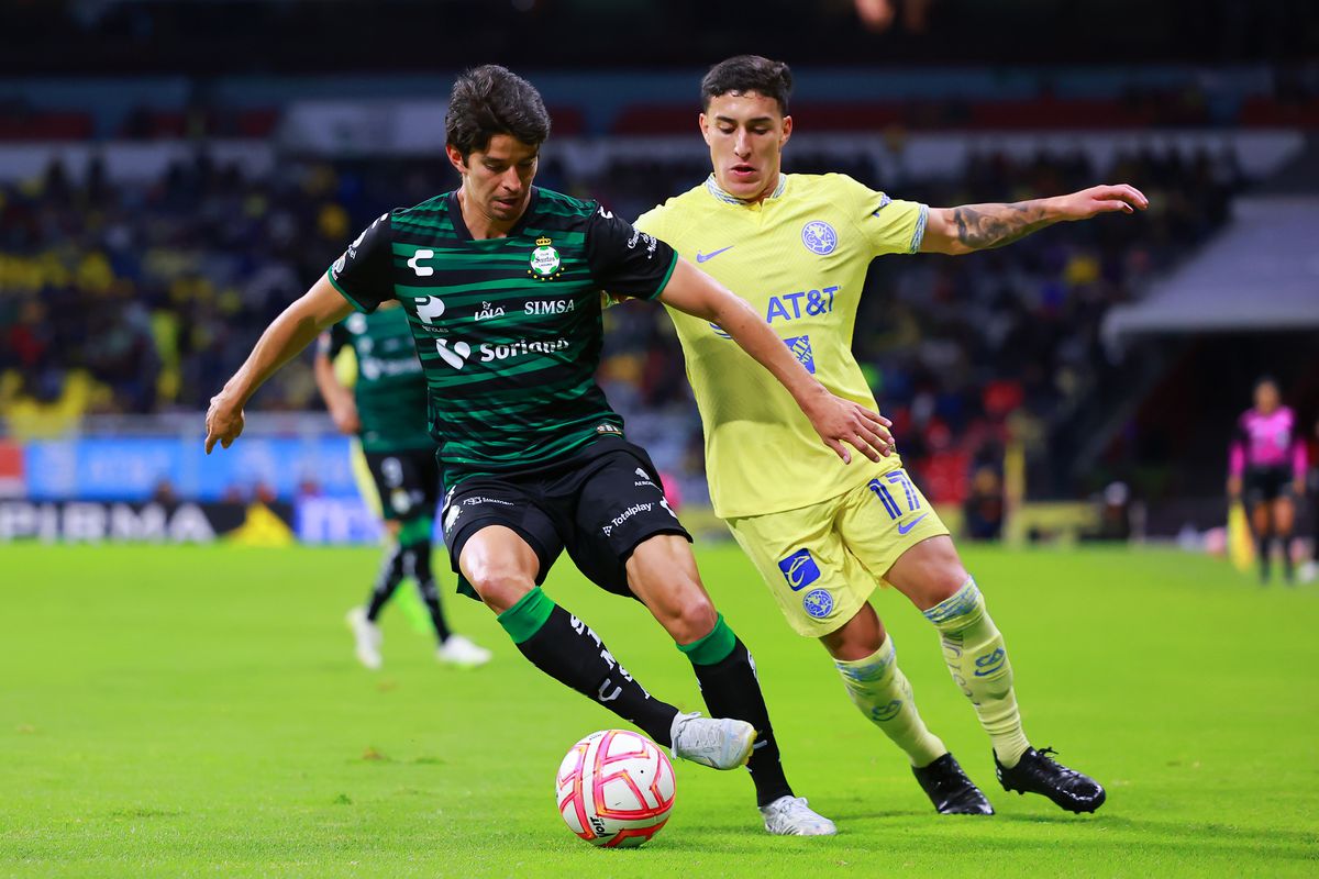 Carlos Orrantia of Santos Laguna battles for possession with Alejandro Zendejas of America during the 5th round match between America and Santos Laguna as part of the Torneo Apertura 2022 Liga MX at Azteca Stadium on September 14, 2022 in Mexico City, Mexico.