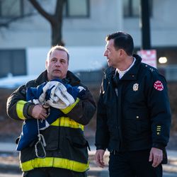 Chicago Fire Department sets up an American Flag to be draped outside the Cook County Medical Examiners Office in perpetration for a procession for a off duty Chicago Police Officer who was fatally shot inside his car in the River North neighborhood, Saturday, March 23, 2019, in Chicago. | Tyler LaRiviere/Sun-Times