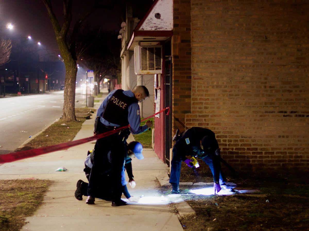 Chicago police investigate the scene of shooting Saturday night that wounded a 13-year-old boy in the 7300 block of South Racine. | Matthew Hendrickson/Sun-Times