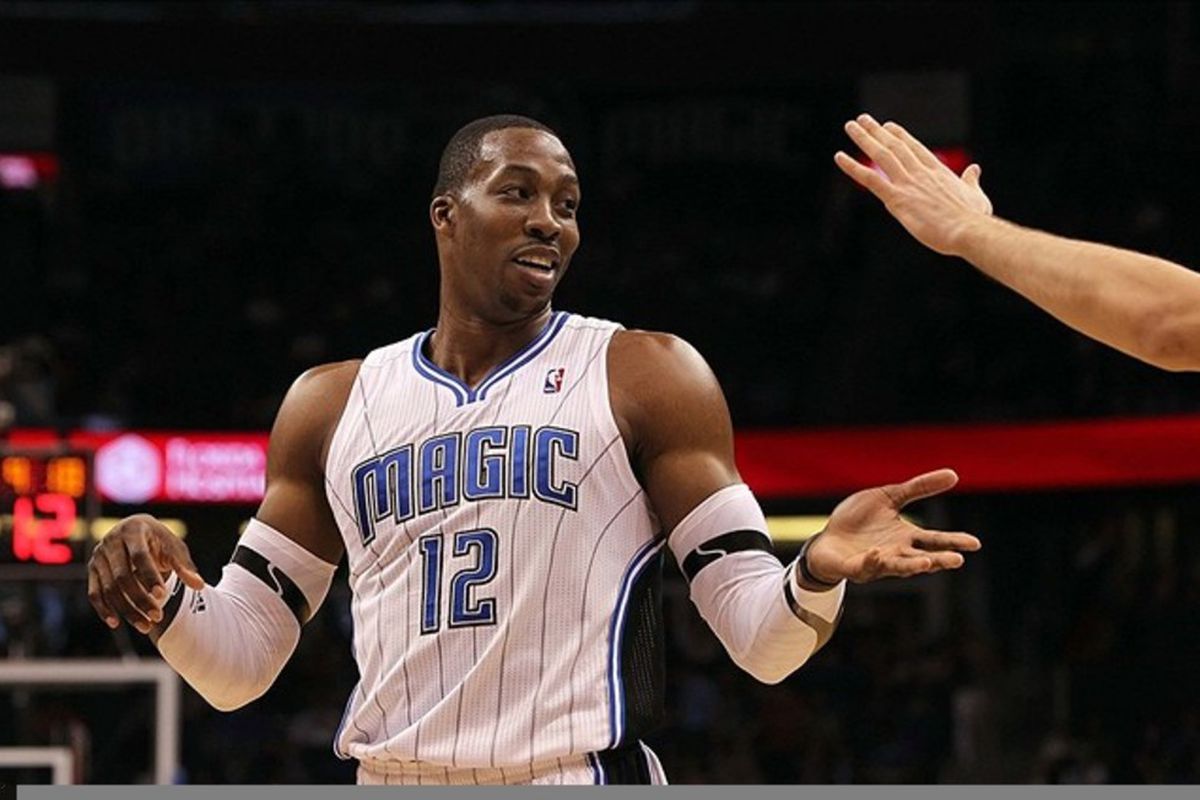 March 3, 2012; Orlando FL, USA; Orlando Magic center Dwight Howard (12) high fives during the second half against the Milwaukee Bucks at Amway Center. Orlando Magic defeated the Milwaukee Bucks 111-98. Mandatory Credit: Kim Klement-US PRESSWIRE