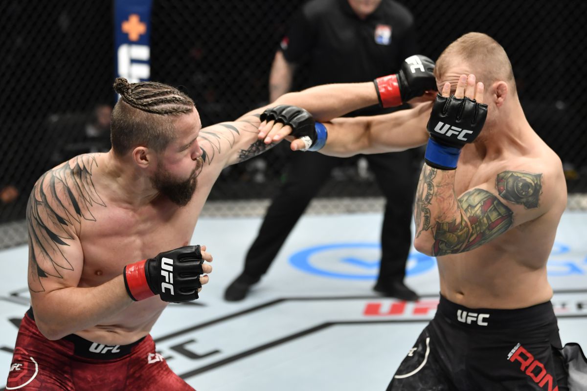 Nicolas Dalby of Denmark punches Jesse Ronson of Canada in their welterweight fight during the UFC Fight Night event inside Flash Forum on UFC Fight Island on July 26, 2020 in Yas Island, Abu Dhabi, United Arab Emirates.