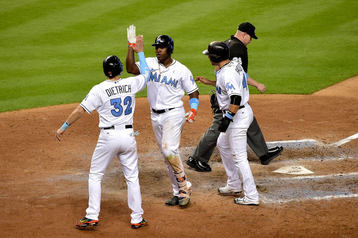 Marcell Ozuna celebrates his eventual game-winning, three-run shot with teammates in the sixth inning.