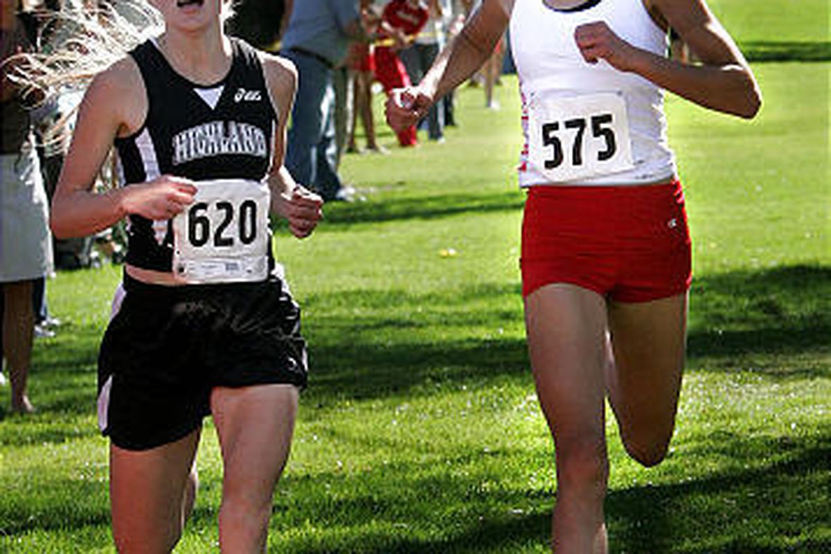 Highland's Kate Stringfellow, left, and East's Madeline Gochnour race toward the finish in the Region 6 championship Wednesday.
