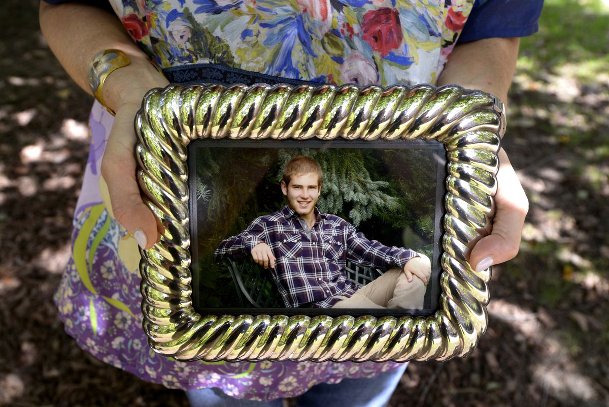 Diane Orley holds a photograph of her son, George, on the University of Michigan campus in Ann Arbor, Mich., on Wednesday, Sept. 12, 2018.. George took his own life when he was a student at the school. Diane and her son Sam got involved with the fledgling