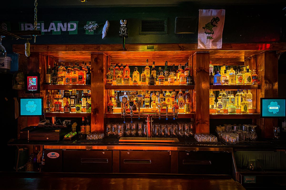 dark bar with bottle-line shelves